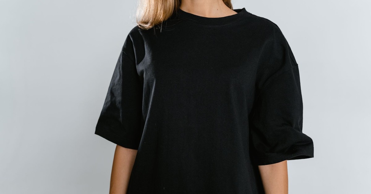 Front view of woman wearing black t-shirt with copy space on white background.