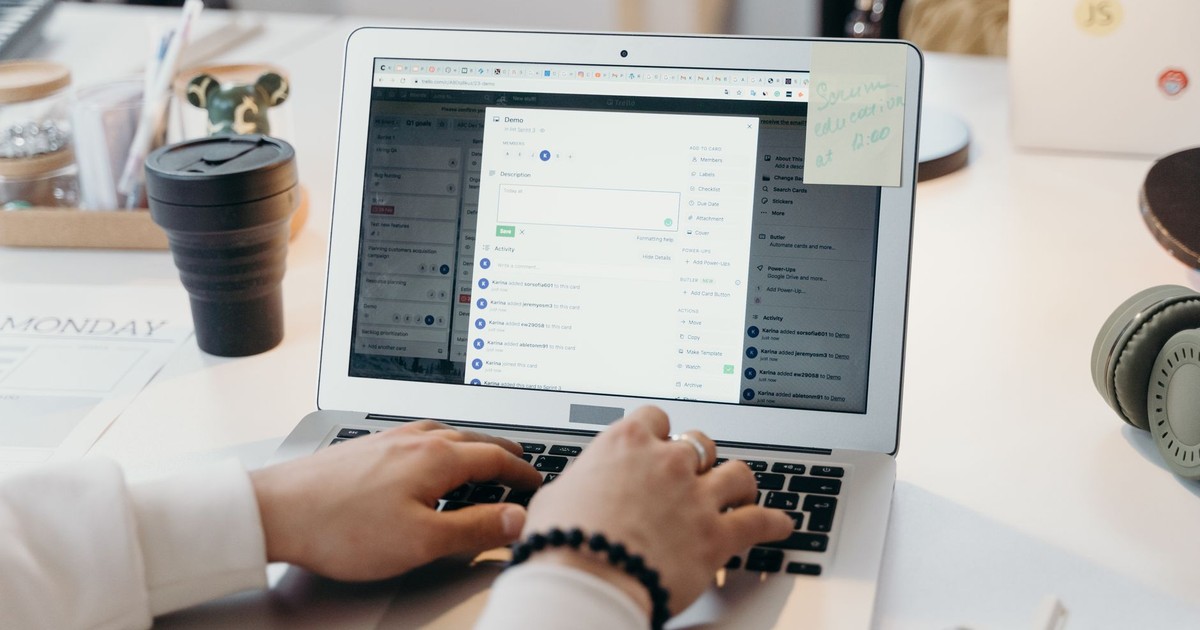 A person typing on a laptop in a bright, modern office setting, showing productivity and technology.