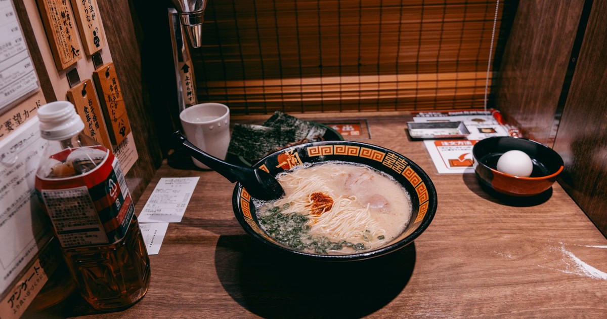 A steaming bowl of ramen served in a private dining booth in Tokyo, Japan.