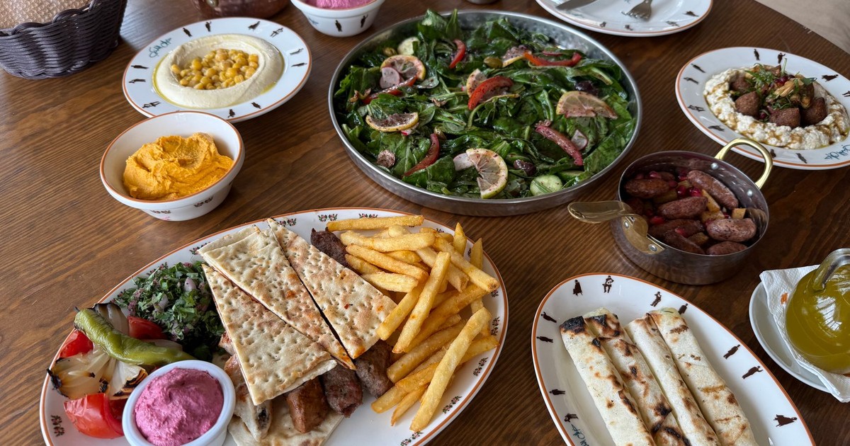 A delicious spread of Mediterranean dishes including salads, hummus, and grilled meats beautifully presented.