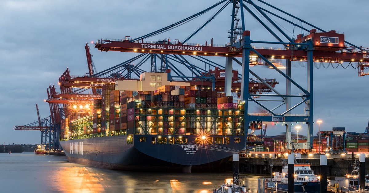 Container ships moored at Terminal Burchardkai in Hamburg, Germany during evening hours.