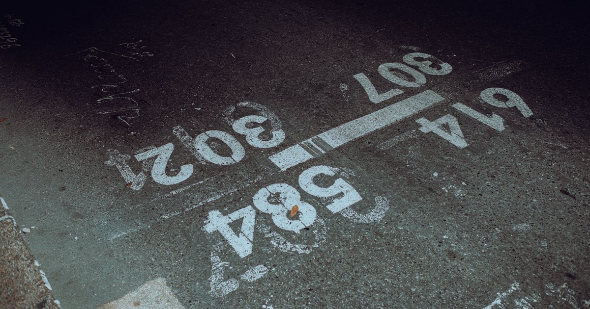 High-angle view of urban road markings on a concrete surface.
