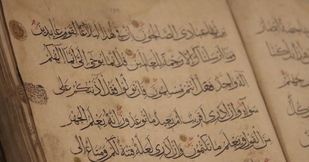 A detailed view of ancient book pages showcasing intricate Arabic calligraphy.