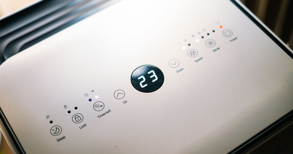 Close-up of a sleek air conditioner control panel displaying temperature.