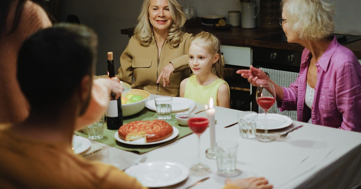 A multigenerational family enjoying dinner together at home, highlighting family bonds and togetherness.
