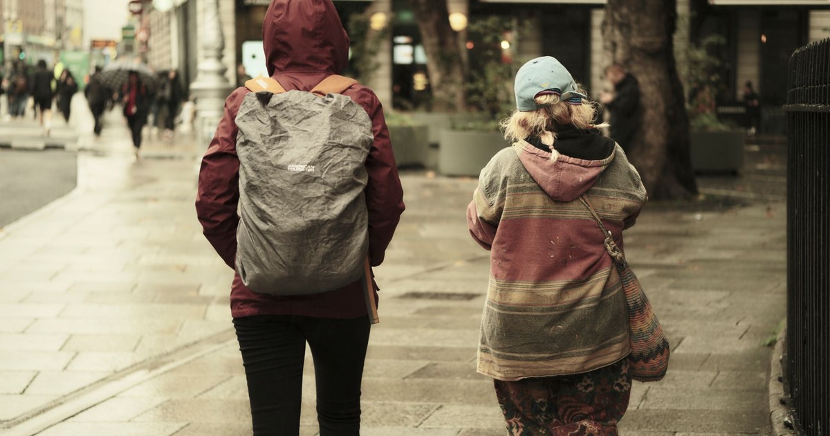 Moody urban street scene with pedestrians walking after a rainstorm.