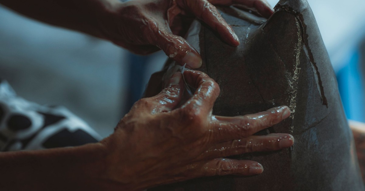 Hands of an artisan skillfully molding clay, showcasing craftsmanship and creativity.