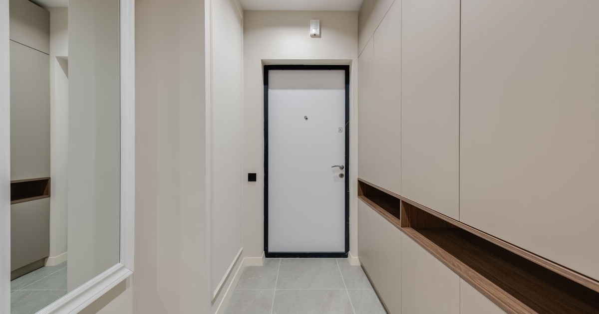Sleek, modern hallway with minimalist design featuring neutral tones and clean lines.