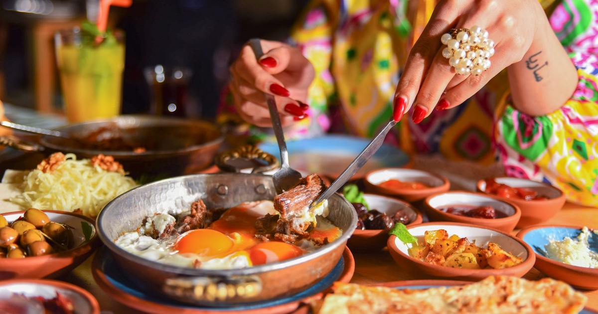 A vibrant breakfast featuring fried eggs and assorted sides, capturing a cultural dining experience.