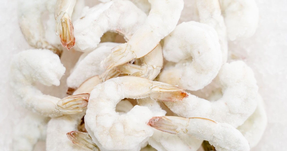 A detailed view of frozen shrimp with icy texture, perfect for culinary stock images.