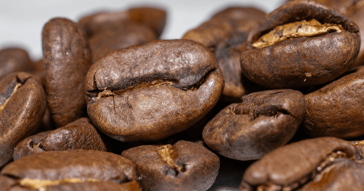 Detailed macro photo showing roasted coffee beans with rich textures.