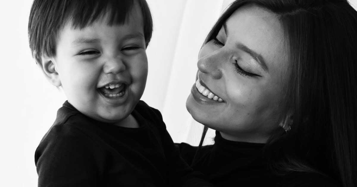 A joyful black and white portrait capturing a mother and child's happy moments.