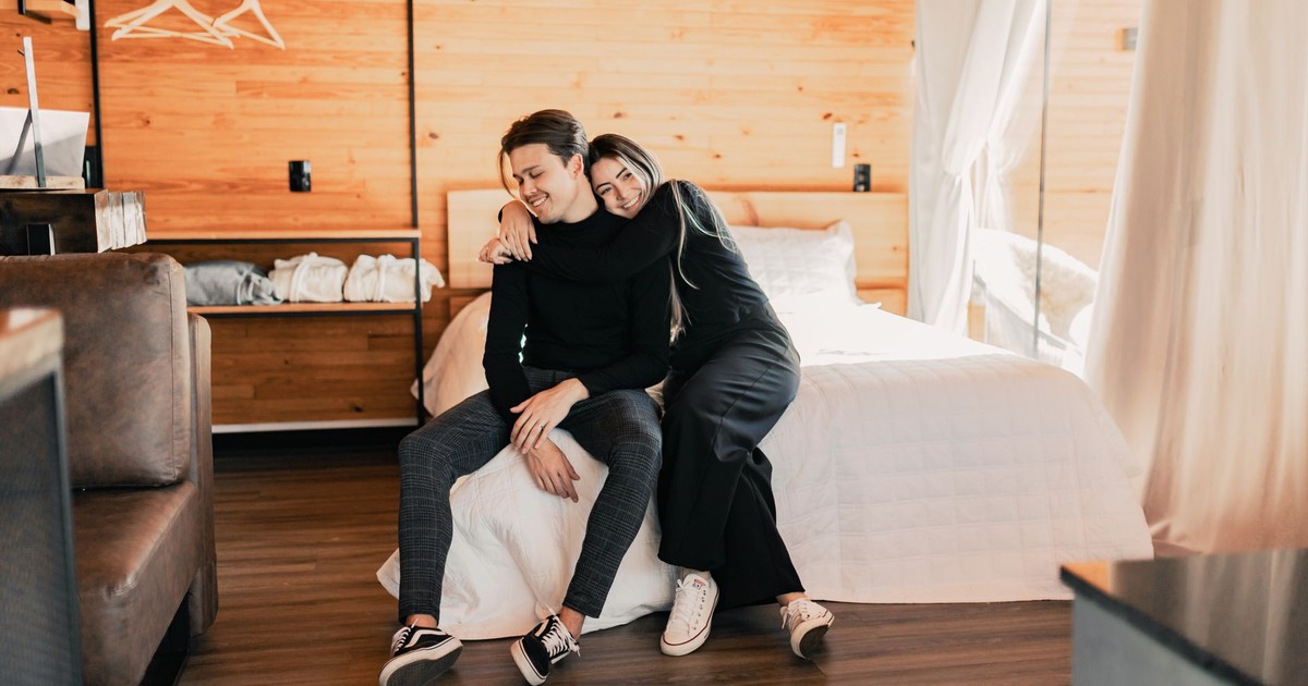 A couple enjoys leisure time together in a stylish, contemporary bedroom.