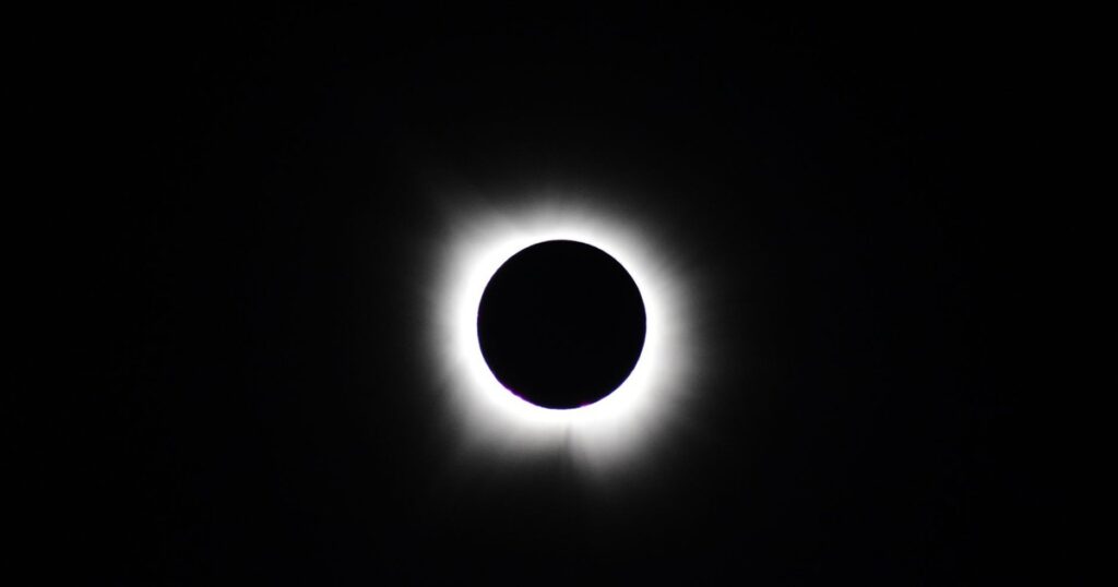 Stunning image of total solar eclipse showing the sun's corona against a dark sky.
