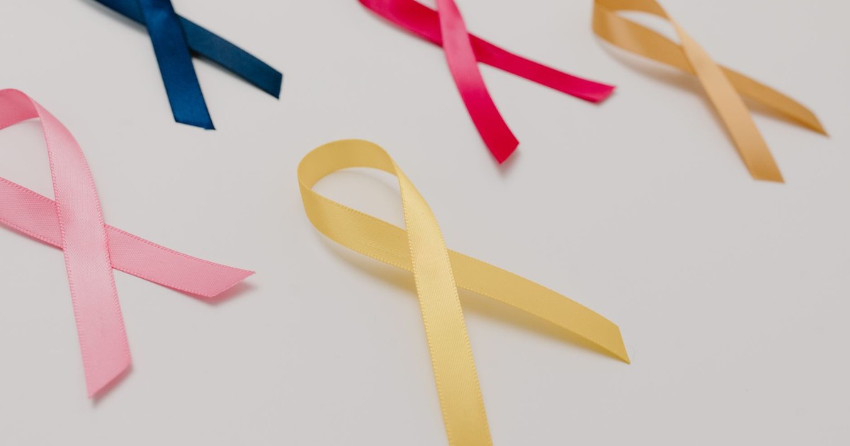 A collection of colorful awareness ribbons symbolizing various causes on a white surface.