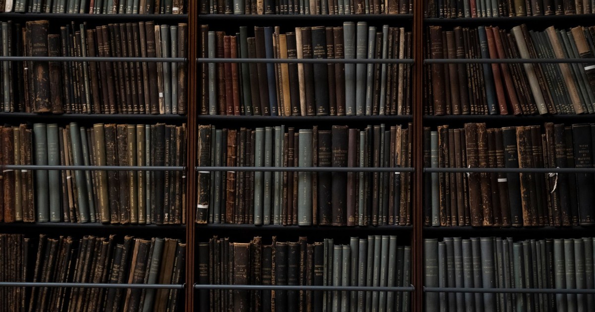 A close-up of vintage books on library shelves in London, showcasing an abundance of literary history.